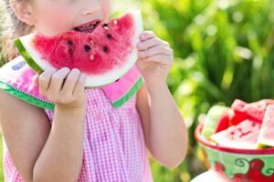 a girl eating watermelon