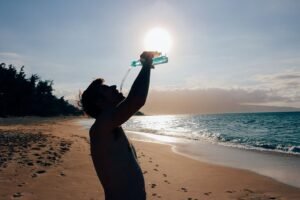 a man drinking water in summer